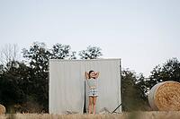 Brown-haired girl, 11, in a cornfield against a beige background [IBR125521151]