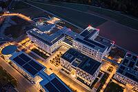 A modern building complex at night from above with glowing street lights, hospital and health campus, Klinikverbund Südwest, Calw, Germany [IBR125527030]
