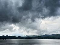 Large lake and mountain with cloudy dark sky [IBR125527031]