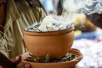 Aromatic herbs burning from a clay pot at the Umbanda smoking ceremony in Brazil [IBR125527090]
