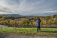 Bern (Berne) Switzerland woman tourist taking photo at old town and Aare River in autumn season [IBR125527109]