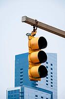 A bright yellow traffic light is visible against a blue modern building in Baltimore, USA [IBR125527119]