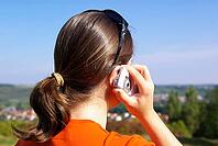 Young woman talking on the phone or texting [IBR125536389]