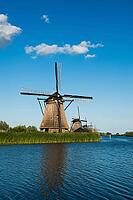 Historic windmills with blue sky on the river, UNESCO World Heritage Site, Kinderdijk, near Rotterdam, province of South Holland, Netherlands [IBR125536390]