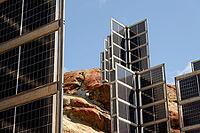 Detail of solar panels in mountains vertically mounted as four wings around central column like tree, photovoltaic plant avoid snow accumulation, future innovation energy concept [IBR125536397]