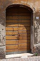 Old patinated door on a dilapidated building, Ravenna, Emilia-Romagna, Italy [IBR125536453]