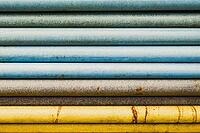 Stacked pipes transition colors blue brown and yellow abstract close up [IBR125536462]