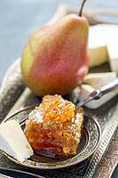 Brie cheese, honey and pear on a metal tray [IBR125557551]