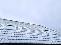 Roof of a house covered in snow on a cold winter day [IBR125557558]