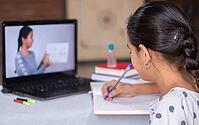Concept of homeschooling or e-learning, young girls busy writing by using in laptop while teachers explain during covid-19 or coronavirus pandemic crisis [IBR125566004]