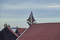 View over saddle roofs decorated with traditional sailboat as roof gable. Makassar, Sulawesi, Indonesia [IBR125566006]