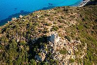 Drone aerial view of a historical Nuraghe tower overlooking the turquoise waters of Porto Giunco beach in Villasimius, Sardinia [IBR125566019]