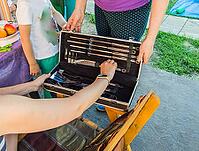 Two woman looking at a luxury barbecue set, in a gift box [IBR125566020]