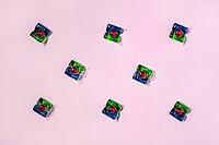Laundry capsules on light pink background, flat lay. Concept of maintaining cleanliness and hygiene [IBR125566071]