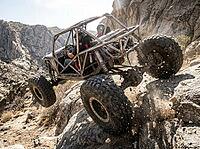 Extreme off road vehicle conquering a challenging rock trail, driver and passenger experiencing the thrill and excitement of a demanding wilderness expedition, AI generated [IBR125592667]