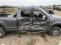 Wrecked gray pickup truck sits in a salvage yard, its side doors crushed, airbags deployed, and chassis bent, illustrating concepts of vehicle damage, collision, and automotive waste, AI generated [IBR125592700]