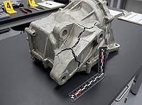 A fractured metal component rests beside forensic measurement scales, with numbered evidence markers and inspection paperwork on the workbench, AI generated [IBR125592703]