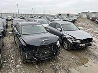 Damaged SUVs displaying significant front end collision impacts parked in a vast outdoor lot, representing the automotive salvage industry, insurance claims, and vehicle recovery operations, AI generated [IBR125592709]
