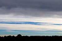 Beautiful panorama of orange and yellow clouds at sunrise and sunset in a blue sky [IBR125606066]