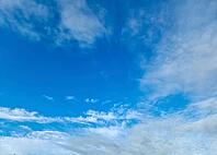 Beautiful fluffy white beautiful cloud formations in a deep blue summer sky [IBR125606070]