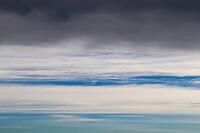 Beautiful fluffy white beautiful cloud formations in a deep blue summer sky [IBR125606084]