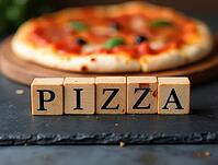 Wooden cubes with the word pizza spelled out on them are placed on a black slate surface, with a freshly baked pizza in soft focus behind, AI generated [IBR125621286]