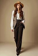 Businesswoman wearing elegant hat, vest, and trousers, striding confidently in a studio setting, showcasing modern office attire, AI generated [IBR125621290]