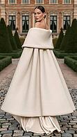 Woman in cream wool opera coat with oversized shawl collar over champagne satin gown on cobblestone path, French chateau garden. AI generated [IBR125621324]