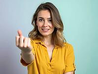 Studio portrait of smiling young woman showing korean love sign against a vibrant two-tone pastel background, AI generated [IBR125621328]