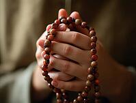 Close-up of hands clasping a rosary in a meditative gesture, AI generated [IBR125621332]