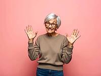 Expressive senior woman showing number ten with both hands, smiling on pink background, AI generated [IBR125621339]
