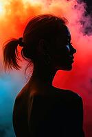Studio portrait featuring a captivating silhouette of a young woman against a backdrop of vibrant, colorful smoke, AI generated [IBR125621343]