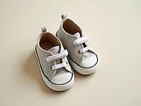 Stylish baby sneakers resting on a neutral backdrop, symbolizing fashion, comfort, and childhood, AI generated [IBR125621358]
