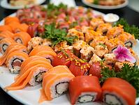Delicious assortment of sushi rolls beautifully presented on a platter, featuring fresh fish, vibrant garnishes, and a delicate pink flower, AI generated [IBR125621359]