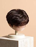 Mens short brown hair wig toupee for balding repair displayed on mannequin head stand on stone block. AI generated [IBR125621366]