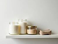 Organic beauty products and candles displayed on a minimalist bathroom shelf, promoting self-care and wellness, AI generated [IBR125636874]