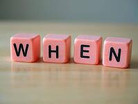 Four pink cubes with black letters form the word when on a wooden table, AI generated [IBR125636886]