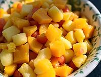 Colorful pieces of fruit salad glistening under sunlight in a bowl, AI generated [IBR125636907]