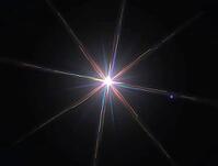 Colorful light rays emanating from a central bright spot creating a star-like effect against a dark backdrop, AI generated [IBR125636942]