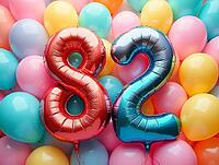 Red and blue number-shaped balloons forming eighty-two surrounded by colorful balloons celebrating an eighty-second birthday, AI generated [IBR125645875]
