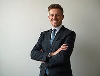 Portrait of a smiling businessman with arms crossed, exuding confidence and professionalism, AI generated [IBR125645950]