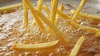 Close up of french fries being submerged in hot oil, creating bubbles and sizzling sounds, during fast food preparation, AI generated [IBR125653443]