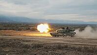 Powerful military tank firing a shot, creating a bright flash and dust cloud in a desert training ground, AI generated [IBR125653466]