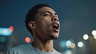 Young man shouting with an open mouth in a city at night with blurred lights in the background, AI generated [IBR125653472]