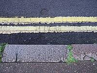 Double yellow line no waiting or parking at any time sign [IBR125654754]