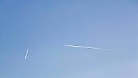 Clear blue sky, two white contrails, chemtrails, contrails of aircrafts, horizontal and vertical, Höxter, Germany [IBR125654821]