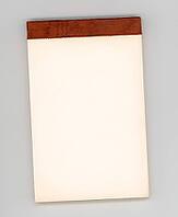 Blank note pad on office desktop, with copy space [IBR125654831]