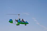 A blue and green tugboat with two people flies against a clear blue sky, Rhineland-Palatinate, Germany [IBR125657367]