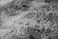 A closeup shot of a water surface covered by multiple fragile bubbles [IBR125657380]