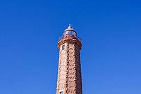 A stone lighthouse rises against a clear, deep blue sky, Estepona, Costa del Sol, Andalusia, Malaga province, Spain [IBR125657393]